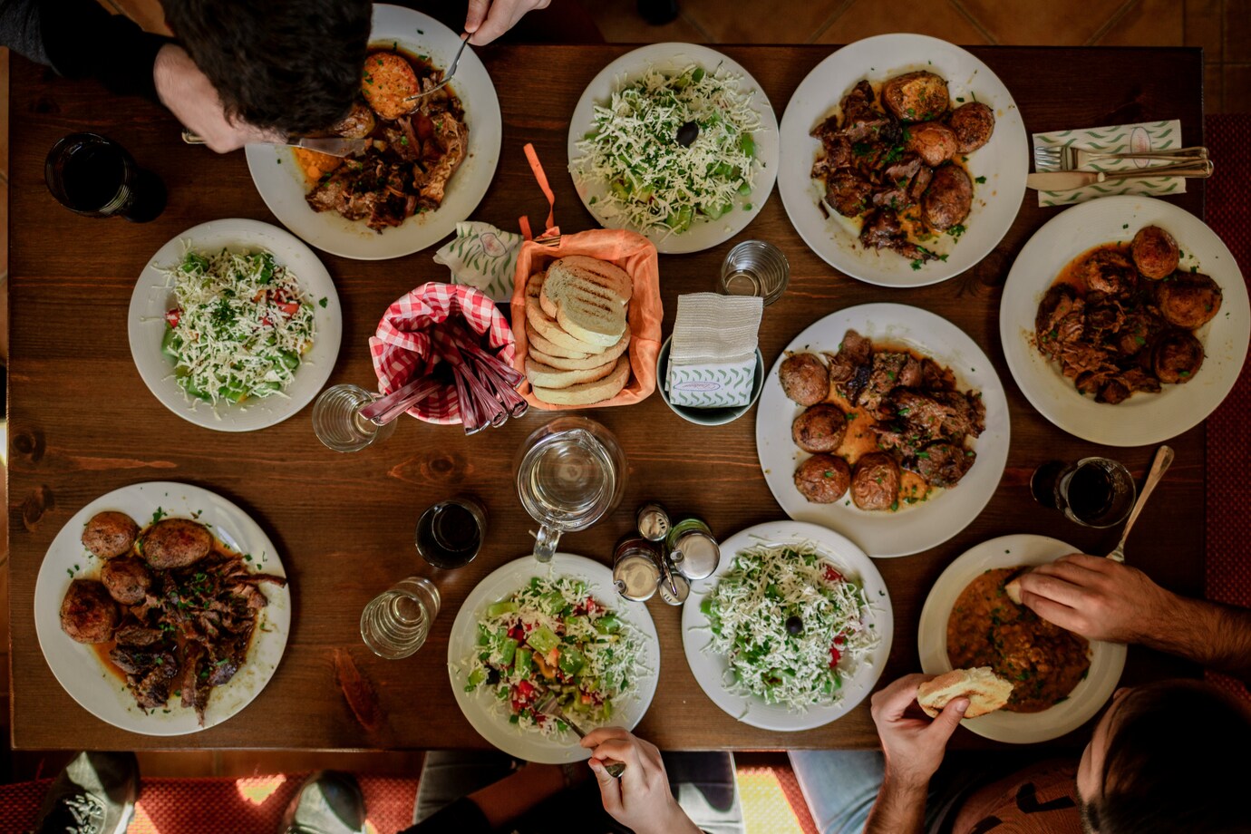Secret Supper Clubs : Friends gathered around a beautifully set table, sharing laughter and handcrafted dishes.