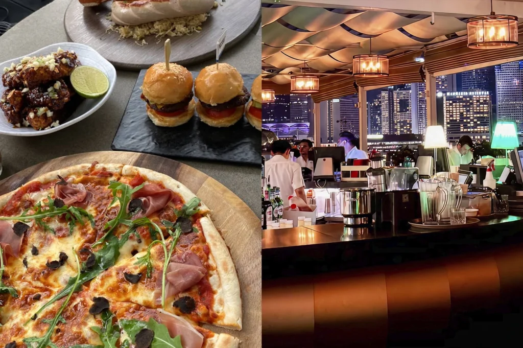 A split-frame image highlighting a social dining scene. On the left, a variety of bar snacks are spread across a stone tabletop, including a prosciutto and arugula pizza topped with black truffles, mini sliders, and glazed wings. On the right, the scene transitions to the interior bar area, where bartenders in white shirts work under warm, hanging lamps with the city's night-time skyline visible through the open-sided structure.