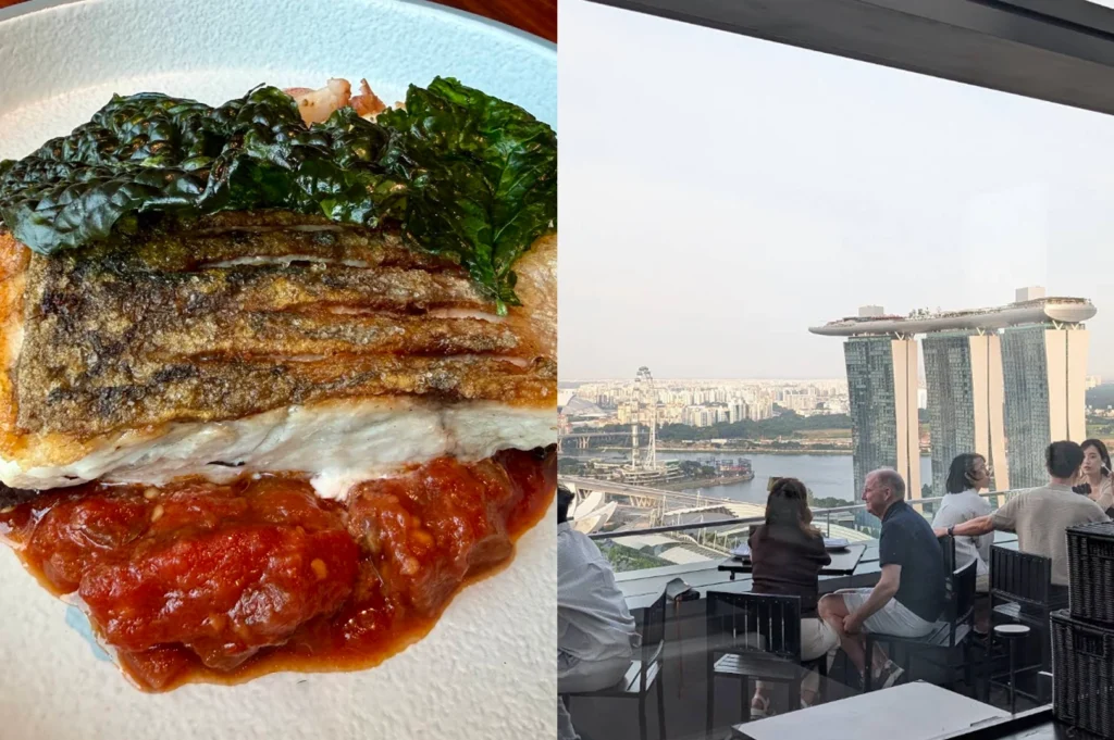A high-contrast composite image. The left half is a tight, unposed shot of a seared fish fillet with a piece of dark kale on top, resting on a bed of chunky red tomato sauce. The right half captures a candid moment on an outdoor rooftop deck during the day, where patrons are seated at black tables with a clear, panoramic view of the Marina Bay Sands and the Singapore Flyer in the distance.
