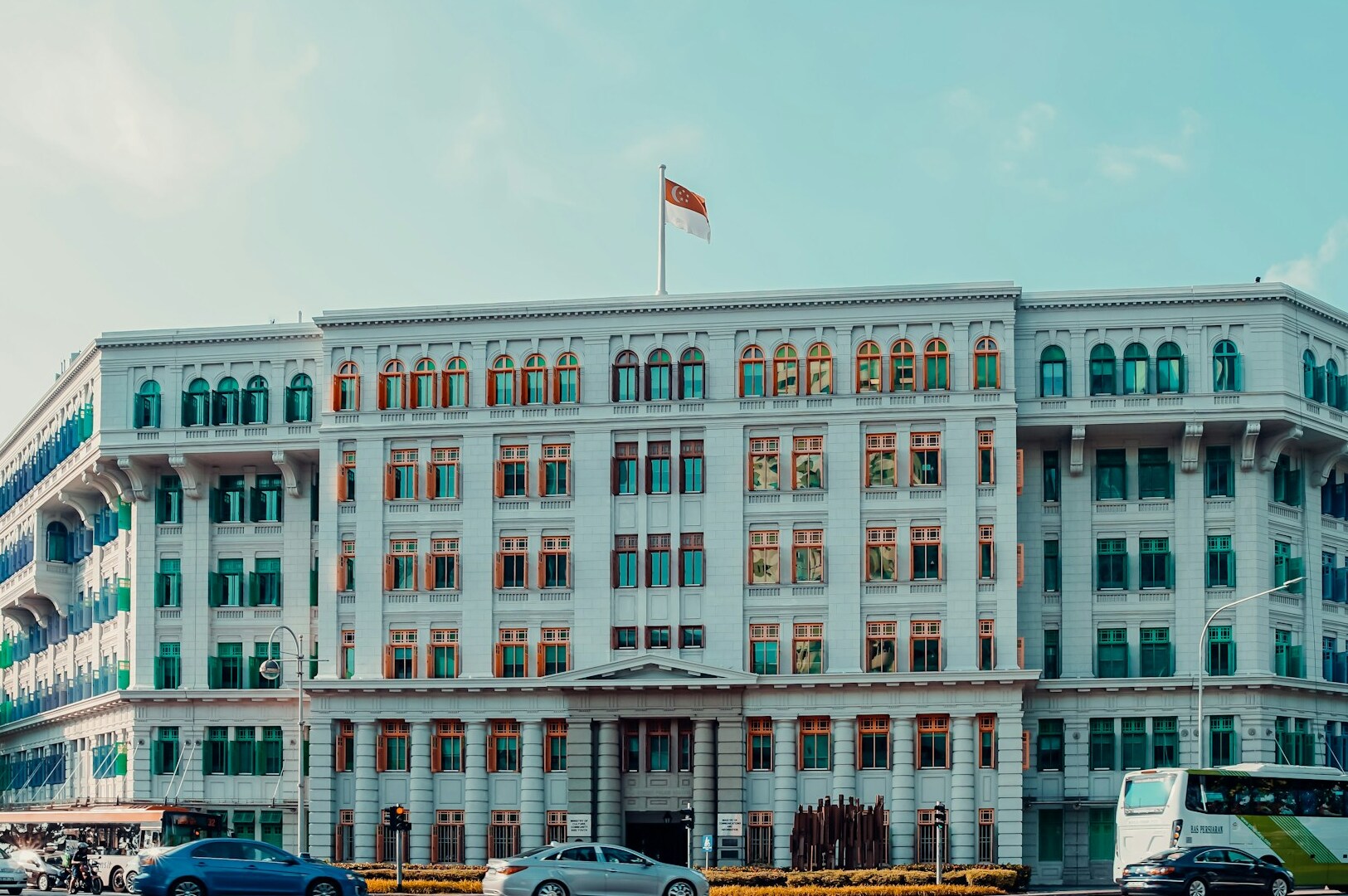 Old Hill Street Police Station, a white building featuring many windows, captured from an off-beat angle.
