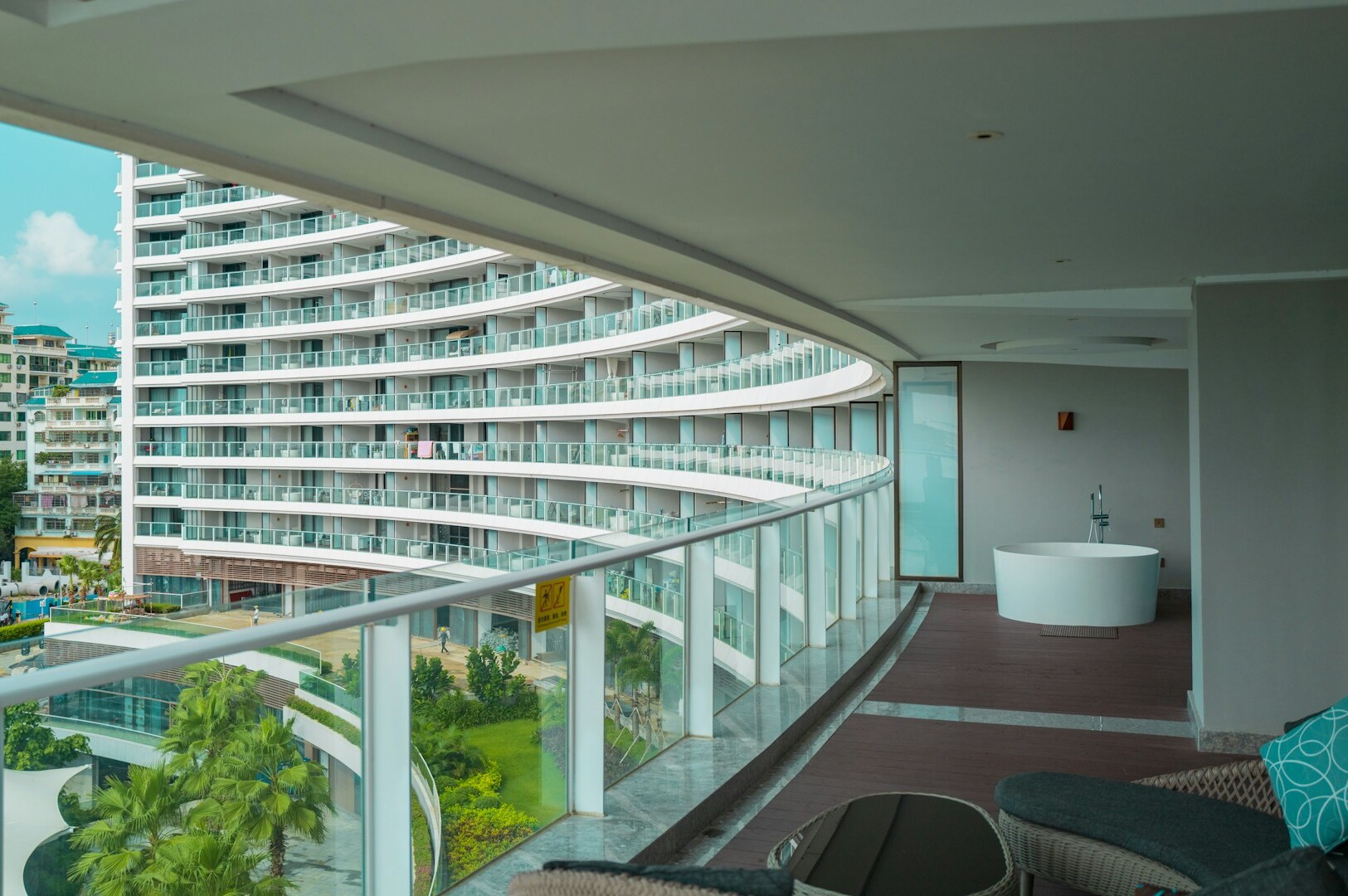 Scenic balcony view of a vibrant city and inviting pool, highlighting the experience at Marina Bay Sands.