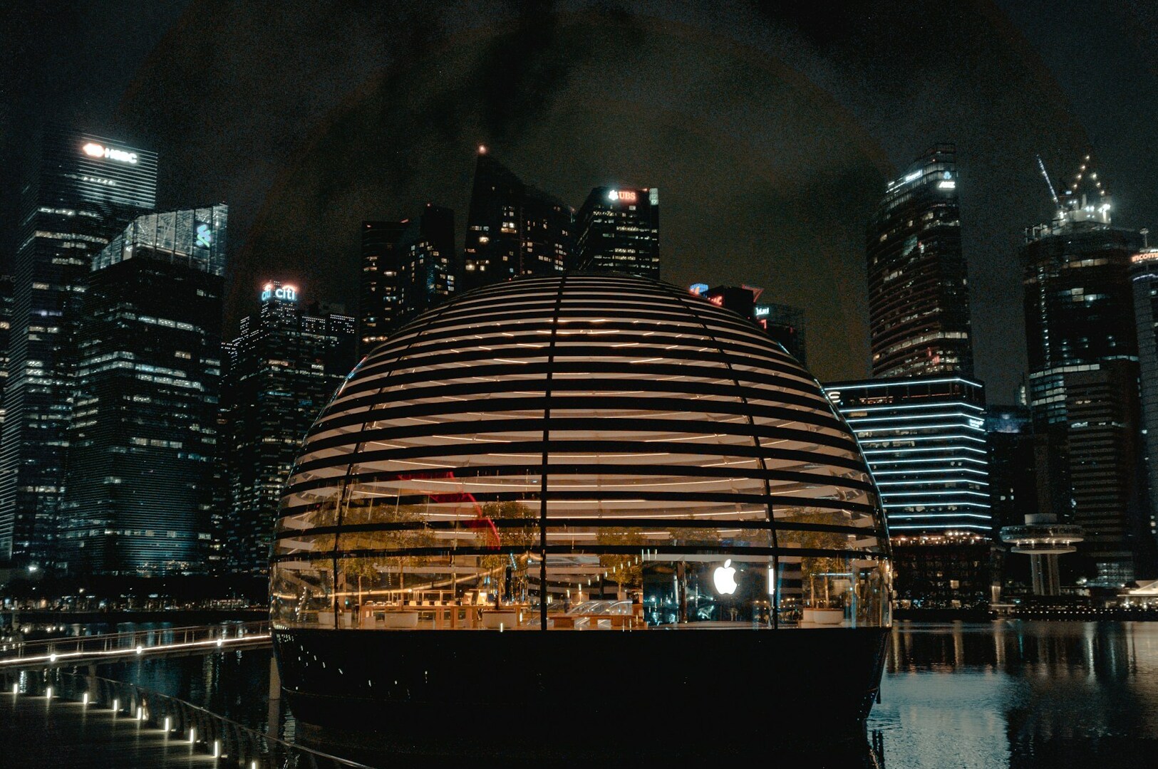 The Opened Apple Floating Store, is set against a city skyline, showcasing a vibrant shopping experience.