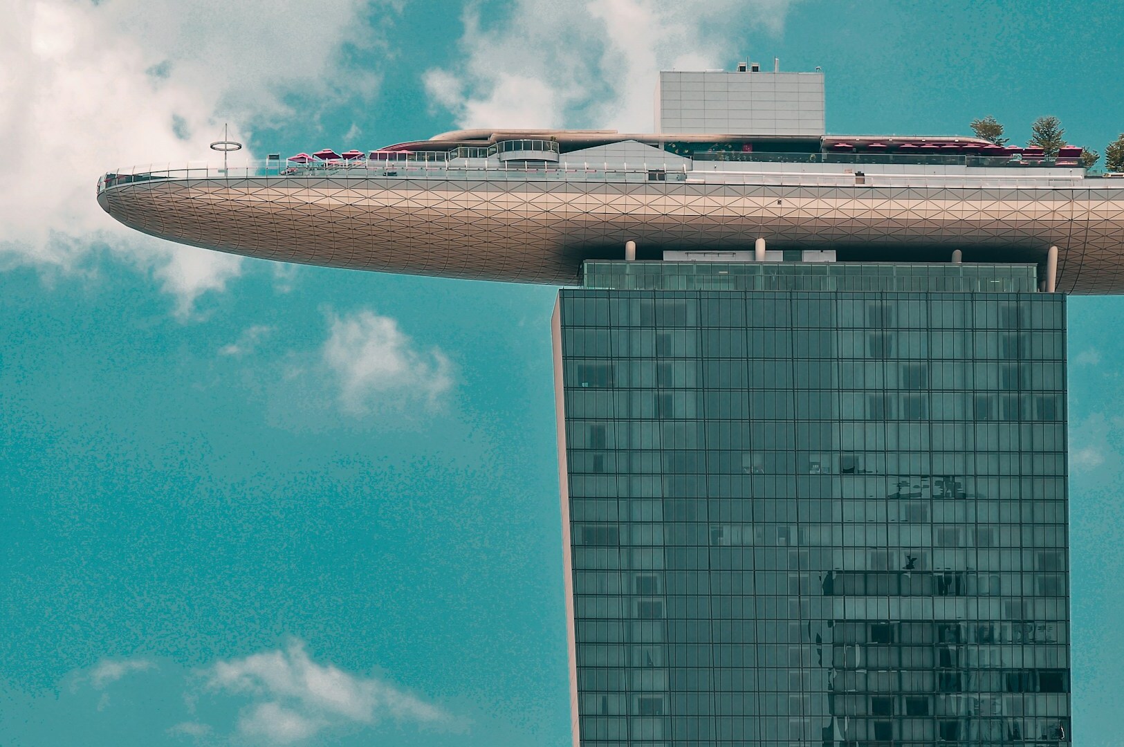 Marina Bay Sands hotel with a distinctive large rooftop structure, highlighting its iconic design and skyline presence.
