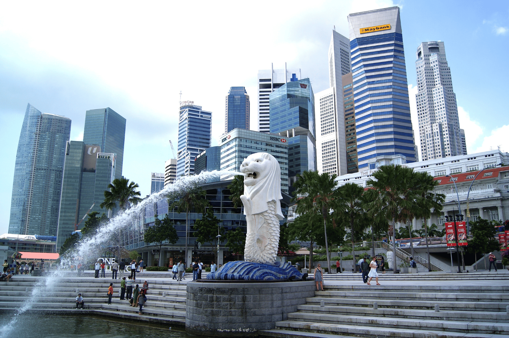 The Merlion statue spouts water into Marina Bay as families stroll along the waterfront promenade, with Singapore’s sleek skyline rising behind—an iconic moment that blends myth, modernity, and a relaxed urban vibe, inviting visitors to explore family-friendly attractions beyond the theme park circuit.