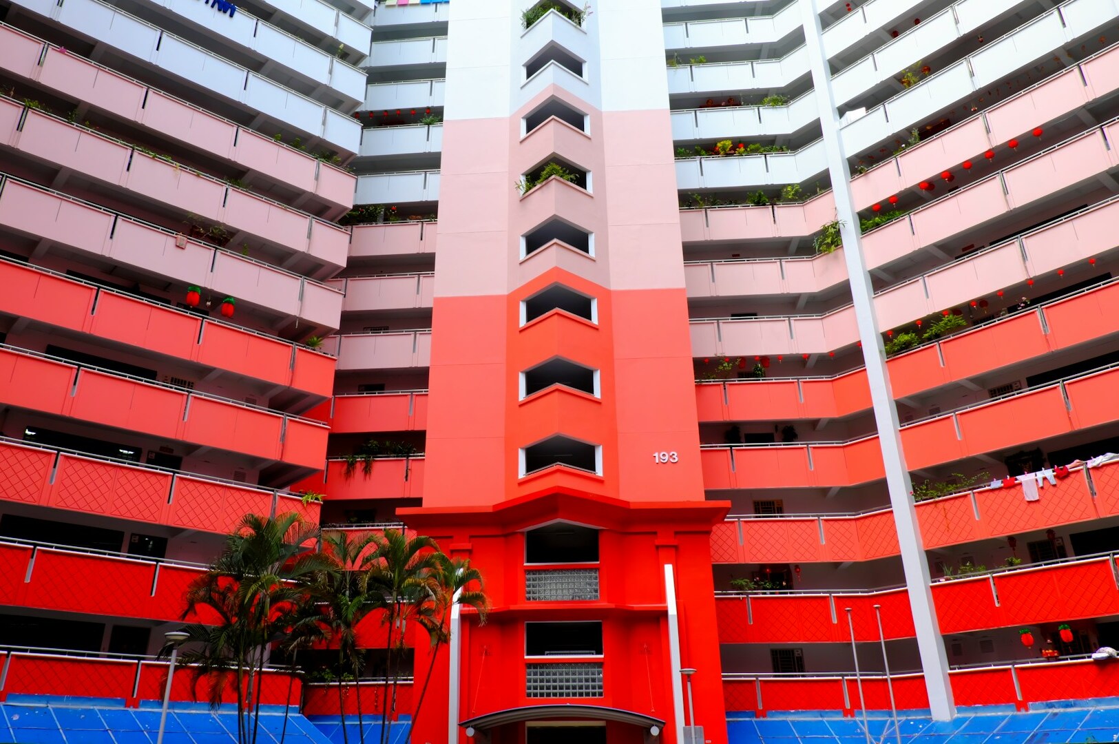 A building featuring a striking red and white facade, part of Themed Hotels Singapore's bold design and immersive experiences.