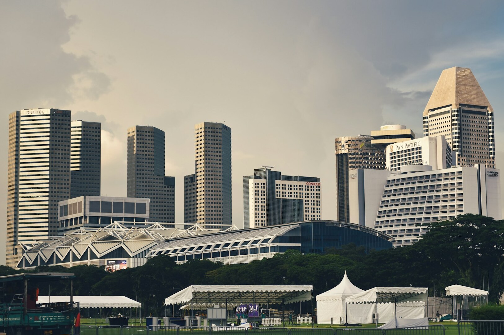 A panoramic view of Singapore's skyline showcasing stylish hotels and co-living spaces against a clear sky.