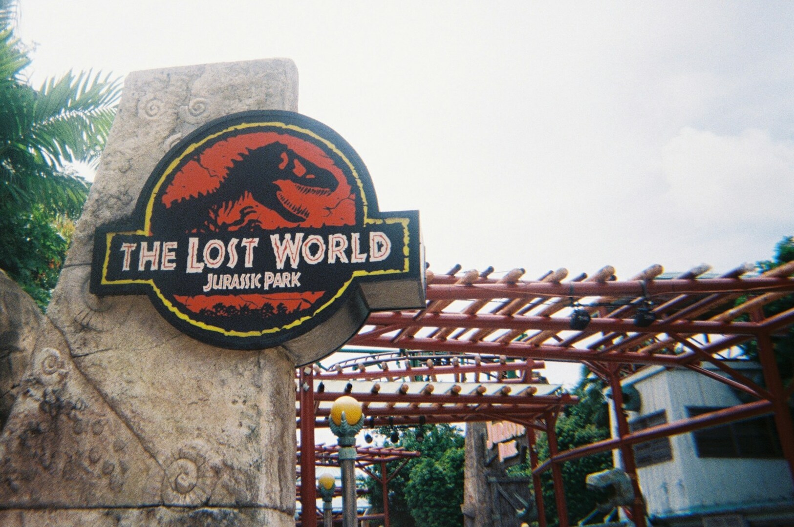 The Lost World at Universal Studios Singapore, featuring lush greenery and dino soarin' attractions.
