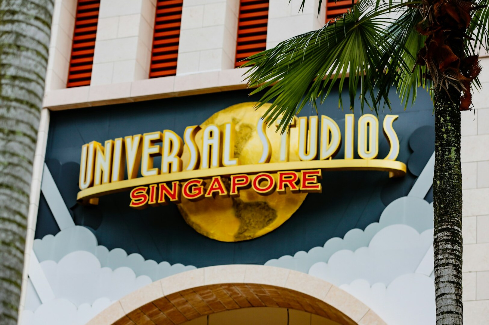 Universal Studios Singapore sign with colorful decorations, inviting guests to enjoy a day of fun and adventure at the theme parks.