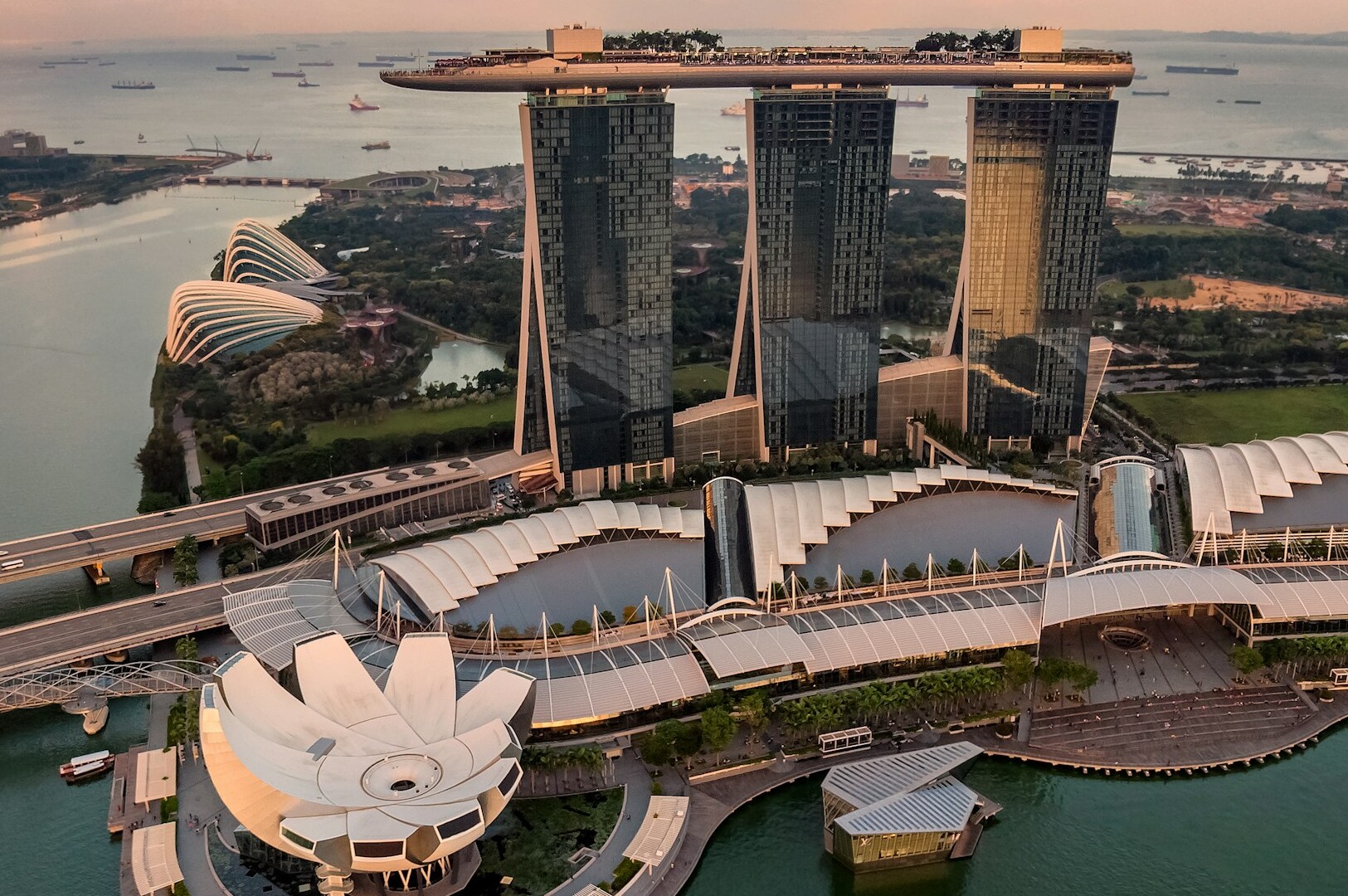 The Marina Bay Sands hotel, featuring three towers and a rooftop park, set against the backdrop of Marina Bay.