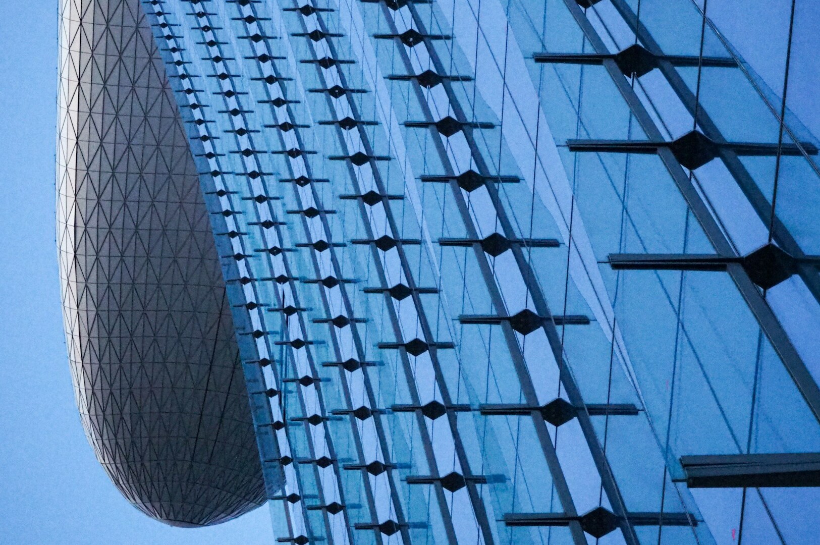 Marina Bay Hotel features a sleek, curved glass design, perfect for family vacation accommodations.