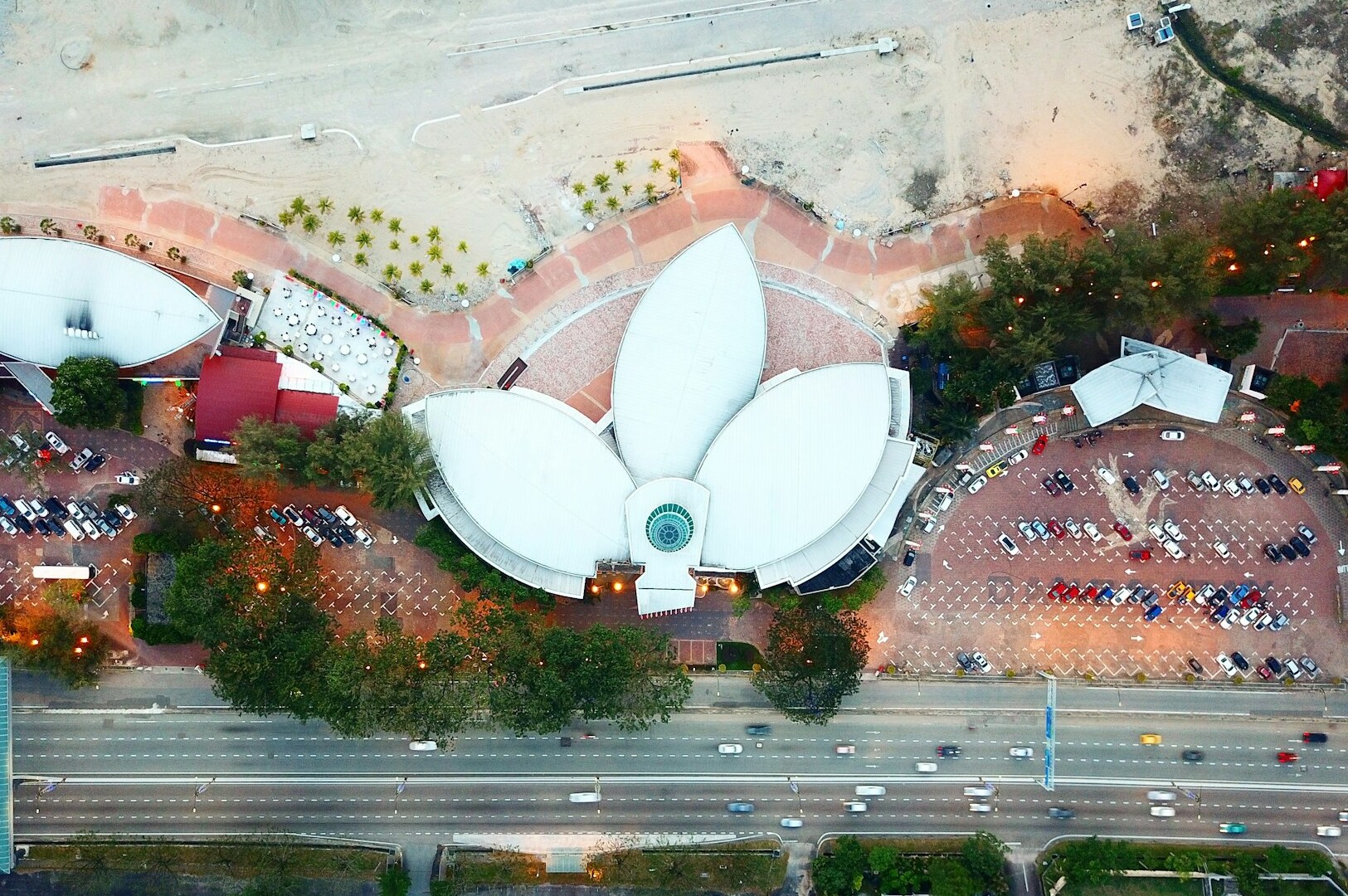 Overhead shot of a prominent hotel featuring a lotus flower on its roof, situated in Johor Bahru city center.