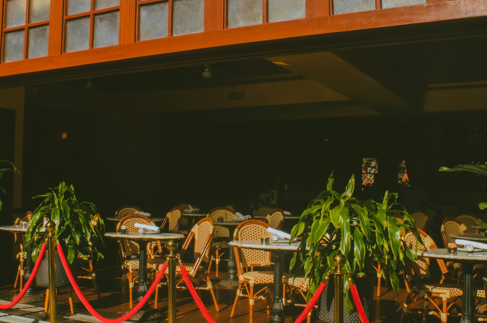 A restaurant at a luxury resort on Sentosa Island, featuring red rope decor for an upscale atmosphere.