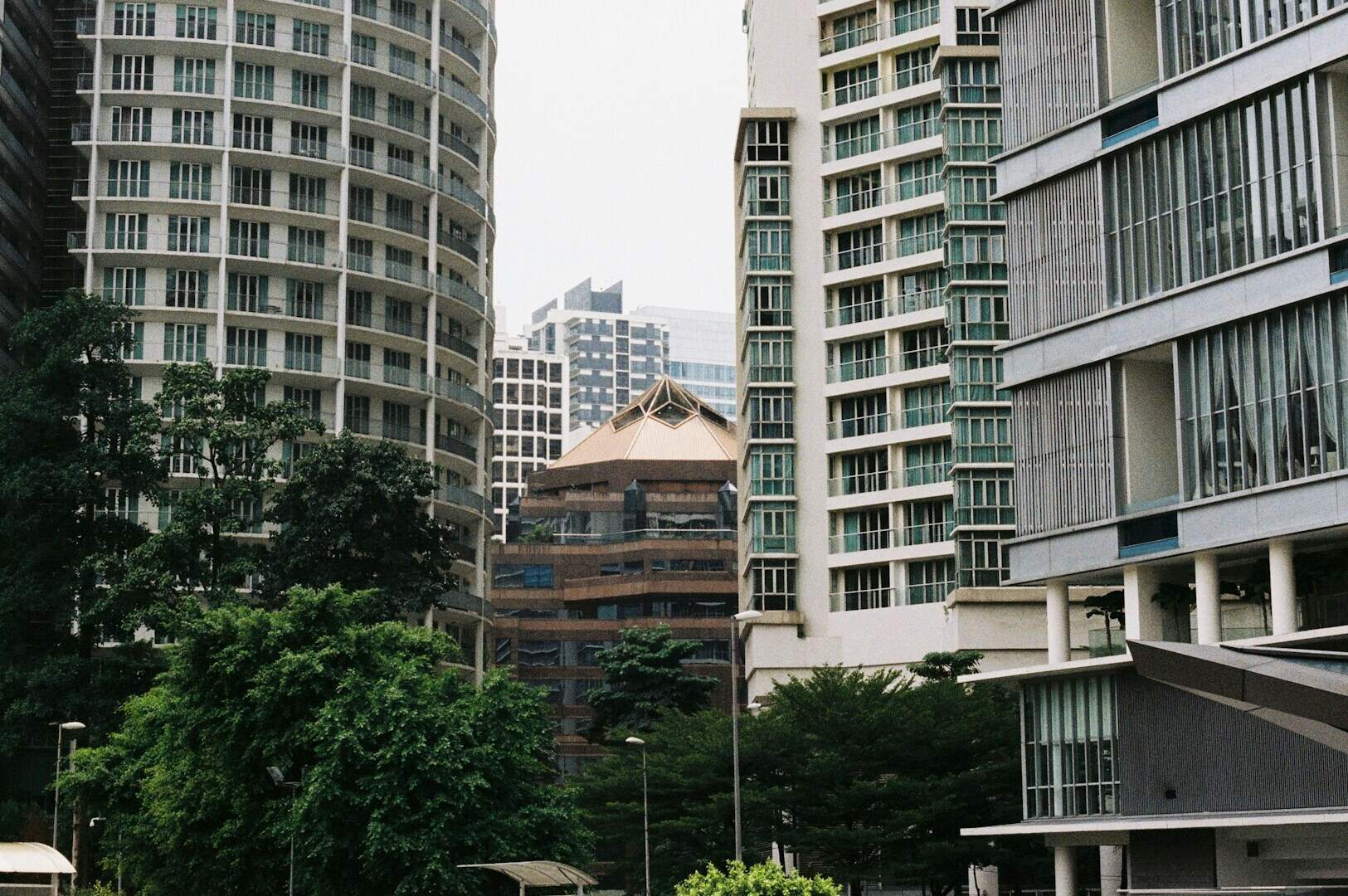 A clock tower on a building in a central neighborhood of Singapore, showcasing local architecture.