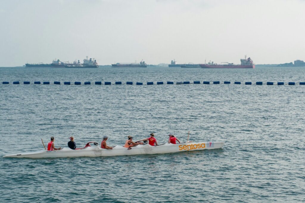  A group of people enjoying a boat ride, highlighting leisure activities near Sentosa's newest hotels.