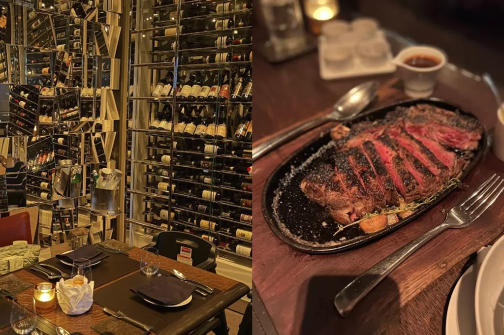 A split-view image showcasing a high-end steakhouse. On the left, the interior features a sophisticated, dimly lit dining room dominated by a massive, floor-to-ceiling glass wine cellar and tables set with formal cutlery and glowing candles. On the right, a close-up of the meal: a thick-cut, sliced steak served on a sizzling black cast-iron platter. The meat is charred on the outside, medium-rare pink on the inside, and garnished with roasted garlic and a sprig of thyme.