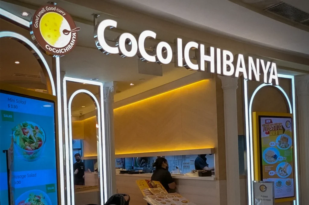 CoCo Ichibanya Singapore restaurant storefront featuring Japanese curry menu displays, ordering counter, and modern dining mall interior.