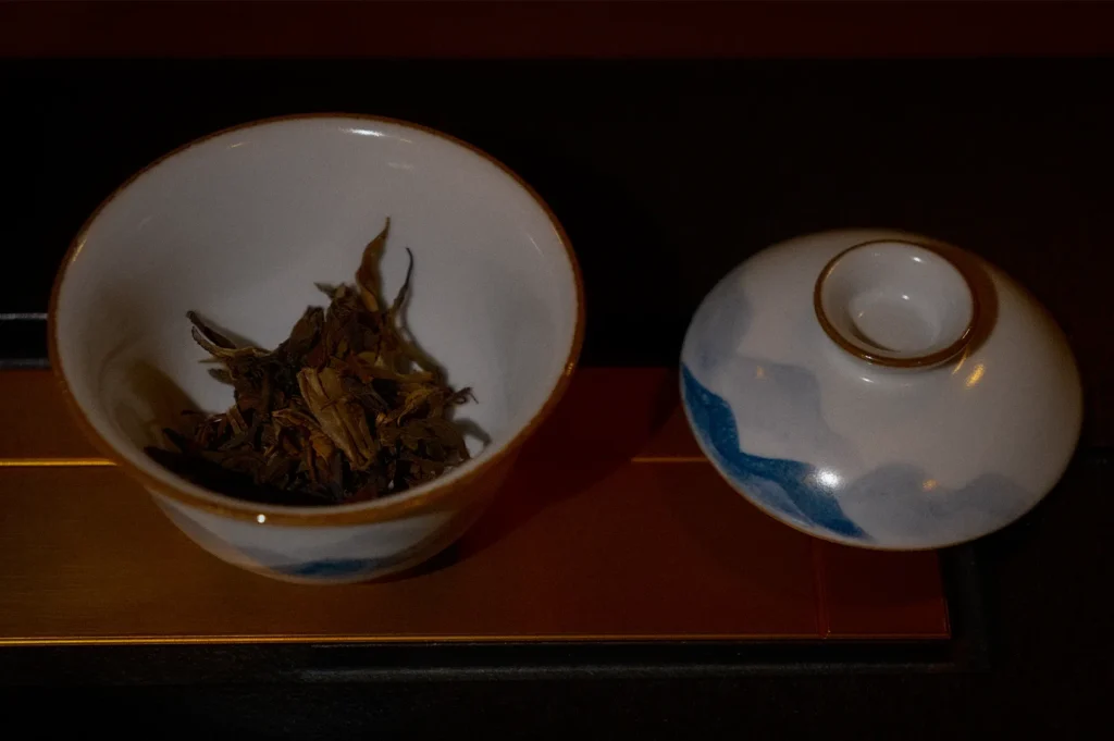 Premium Chinese loose leaf tea displayed in a traditional gaiwan at Tea Room by Ki-Setsu in Orchard Plaza, Singapore. High-quality tea leaves are presented in elegant porcelain teaware for an authentic Chinese tea tasting and tea appreciation experience.